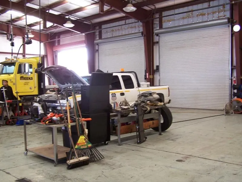 Busy workshop with multiple vehicles under repair